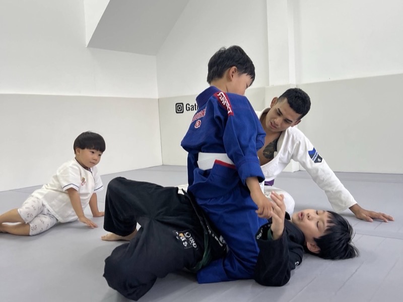 Children practising Brazilian Jiu-Jitsu drills in a supervised kids class in Chiang Mai
